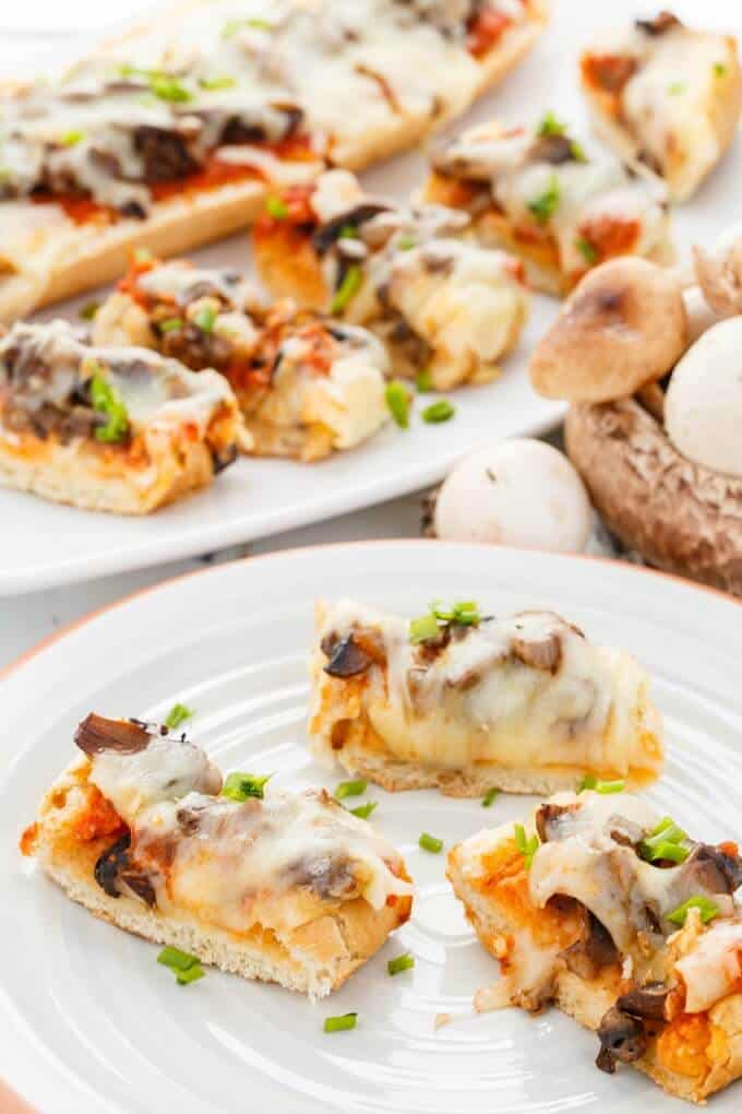 Vegetarian Mushroom Pizza Bread  on white plate and white tray with mushrooms on plate