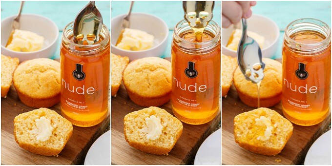 Buttermilk Honey Cornbread Muffins on wooden pad with jar of honey being poured from spoon, butter in bowl in the background
