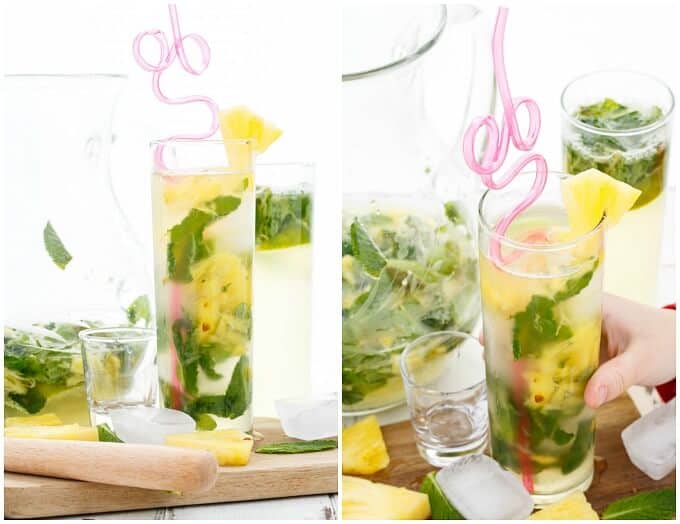 Fresh Pineapple Mojitos in glass cups with straw on wooden pad with ice cube, pineapples, glass shot, herbs and glass pitcher