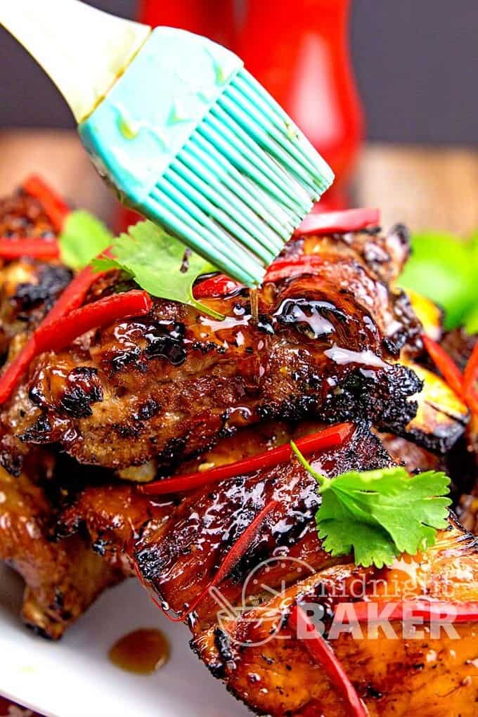 Thai sweet chili ribs on white plate with blue brush over