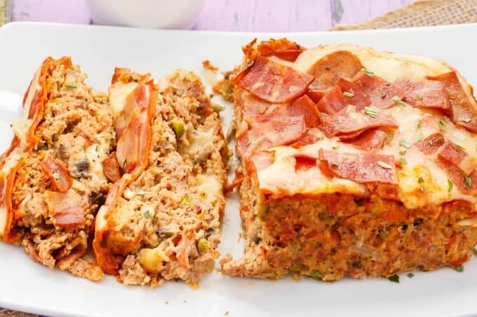 Turkey Pizza Meatloaf partially sliced on white tray