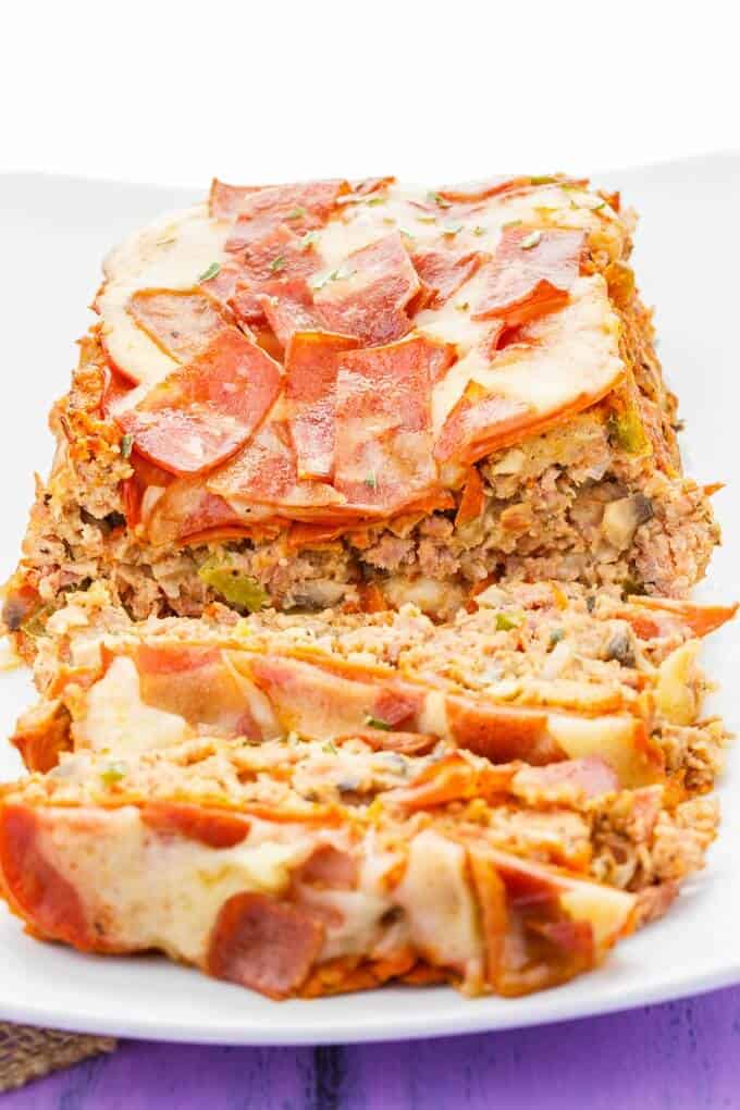 Turkey Pizza Meatloaf partially sliced on white tray