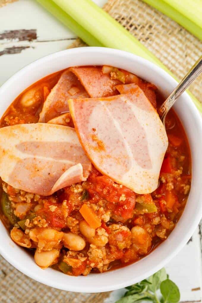 Turkey Bacon Chili in white bowl with spoon