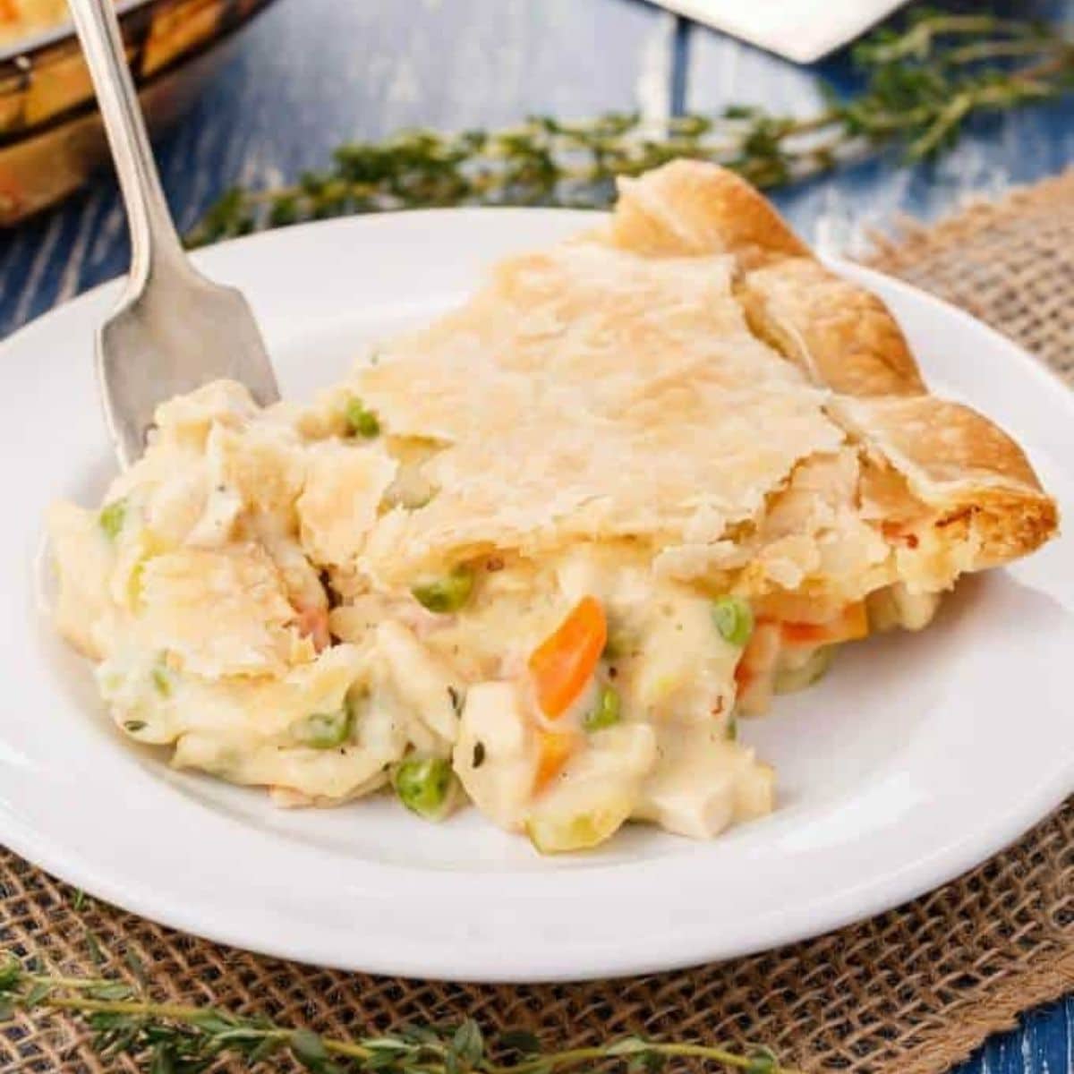 Hearty vegetarian pot pie on white plate with fork