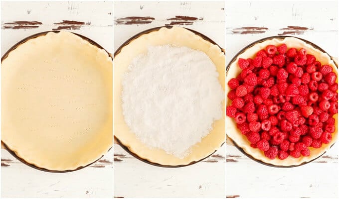 Homemade Raspberry Pie dough in baking pot with with sugar and rapsberries on the top on white brown table.