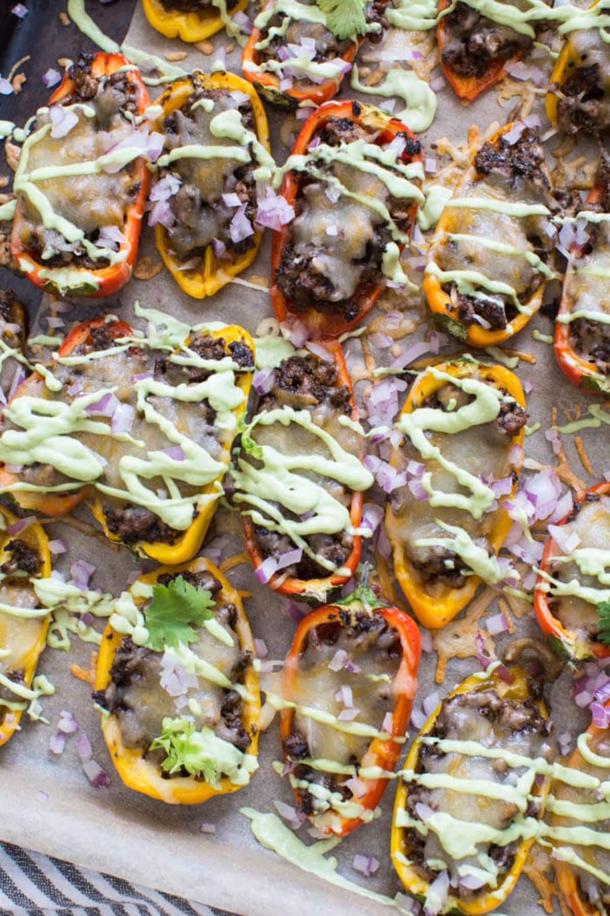 Delicious Mini Bell Pepper Nachos with Avocado Cream on a tray.