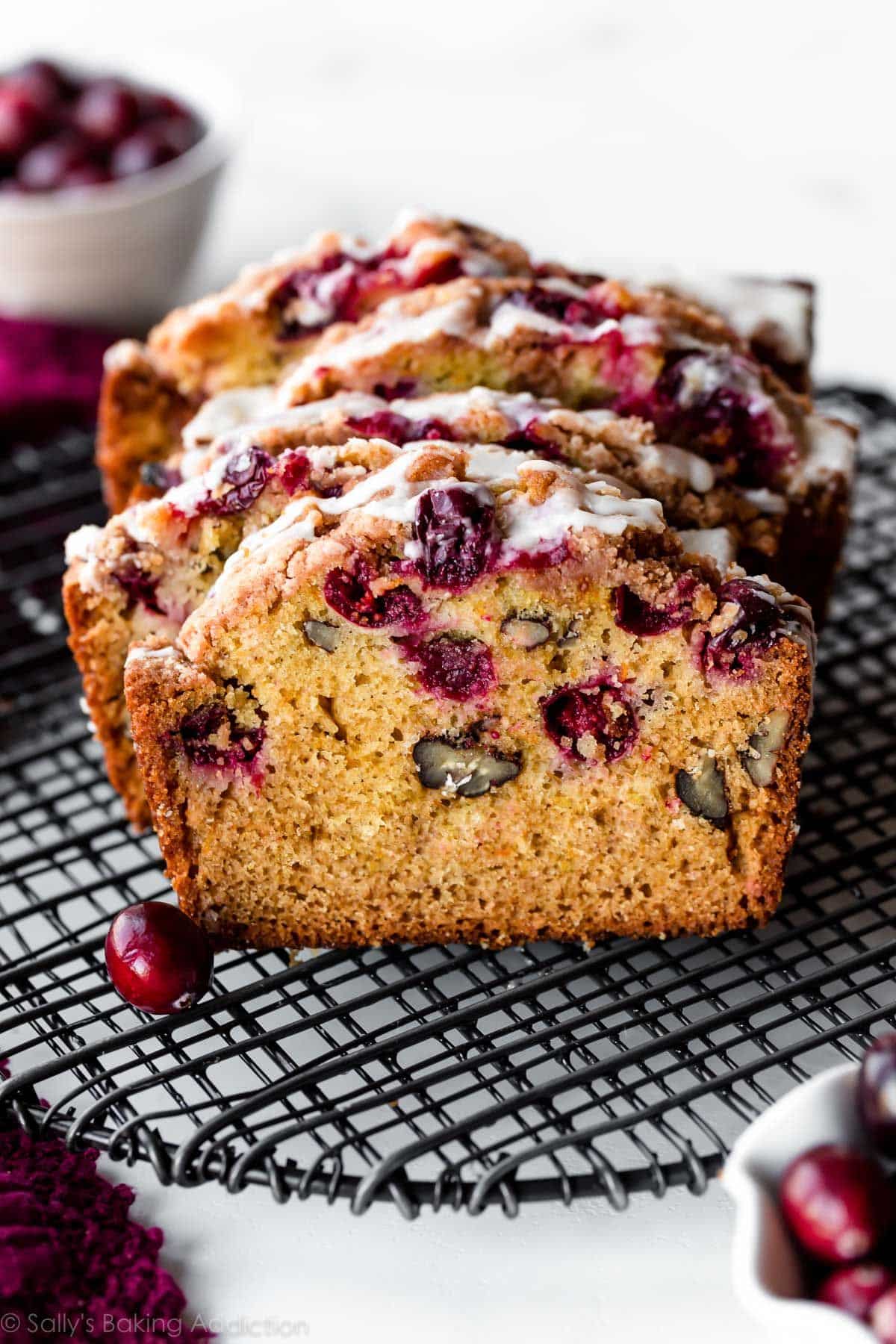 Sliced Orange Glazed Cranberry Bread on a resting grid.