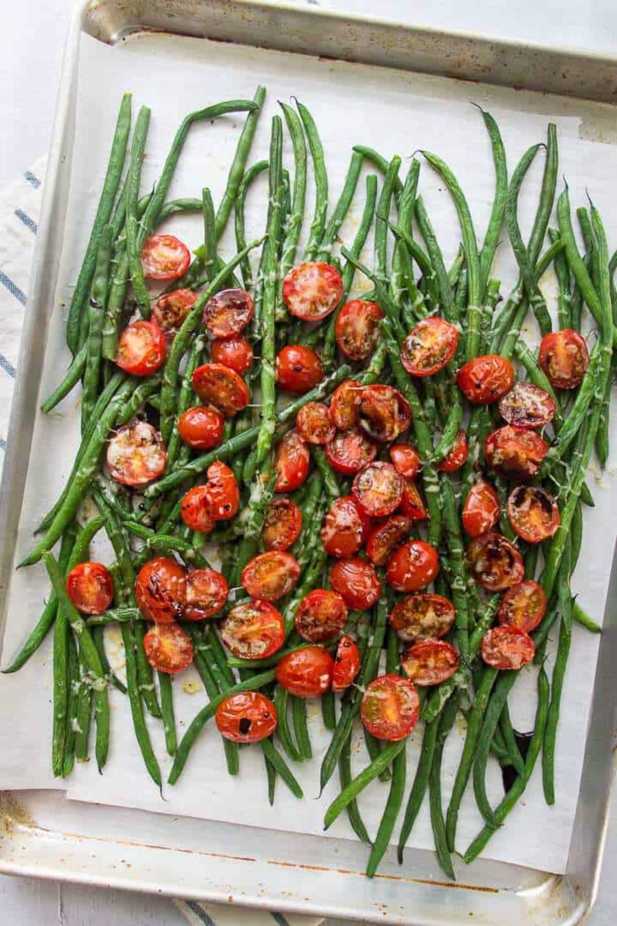Healthy Mediterranean Green Beans and Tomatoes on a baking tray.