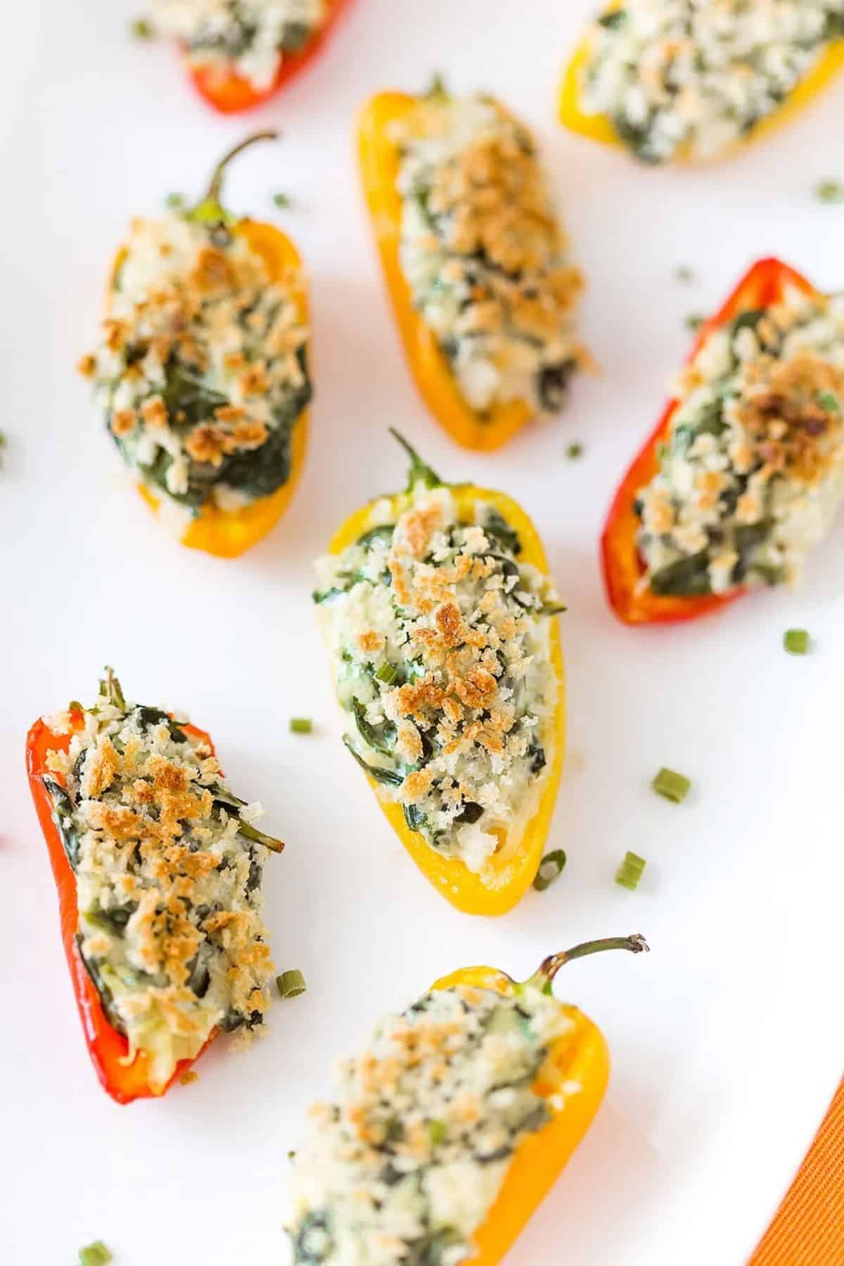 Scrumptious Spinach Artichoke Stuffed Mini Peppers on a white tray.