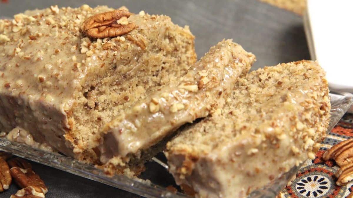 Partially sliced Butter Pecan Bread with Butter Pecan Glaze on a tray.