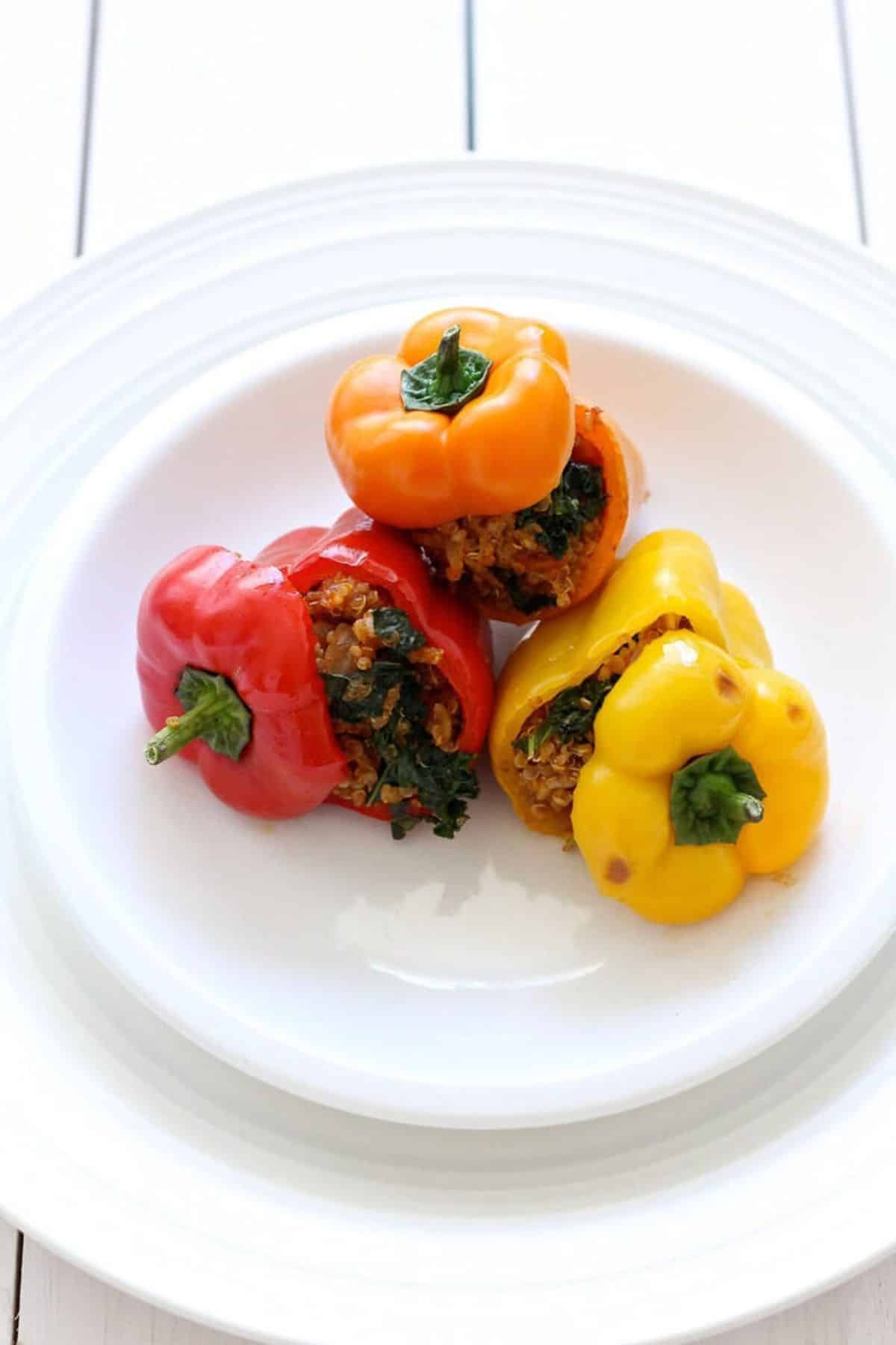 Tasteful Quinoa and Turkey Stuffed Mini Bell Peppers on a white plate.