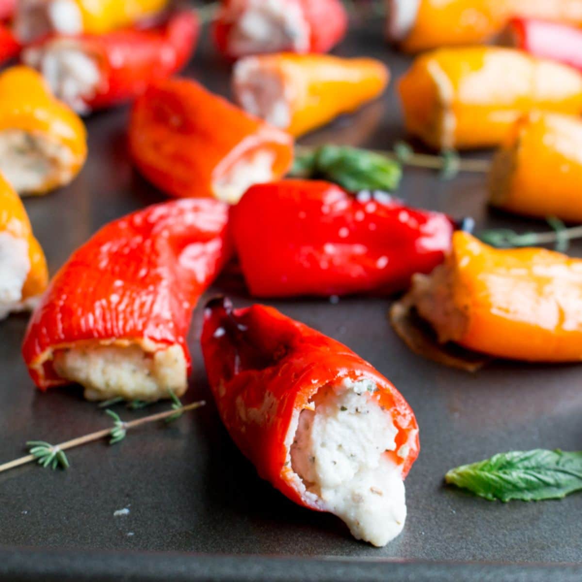 Scrumptious Feta Stuffed Mini Peppers on a black tray.