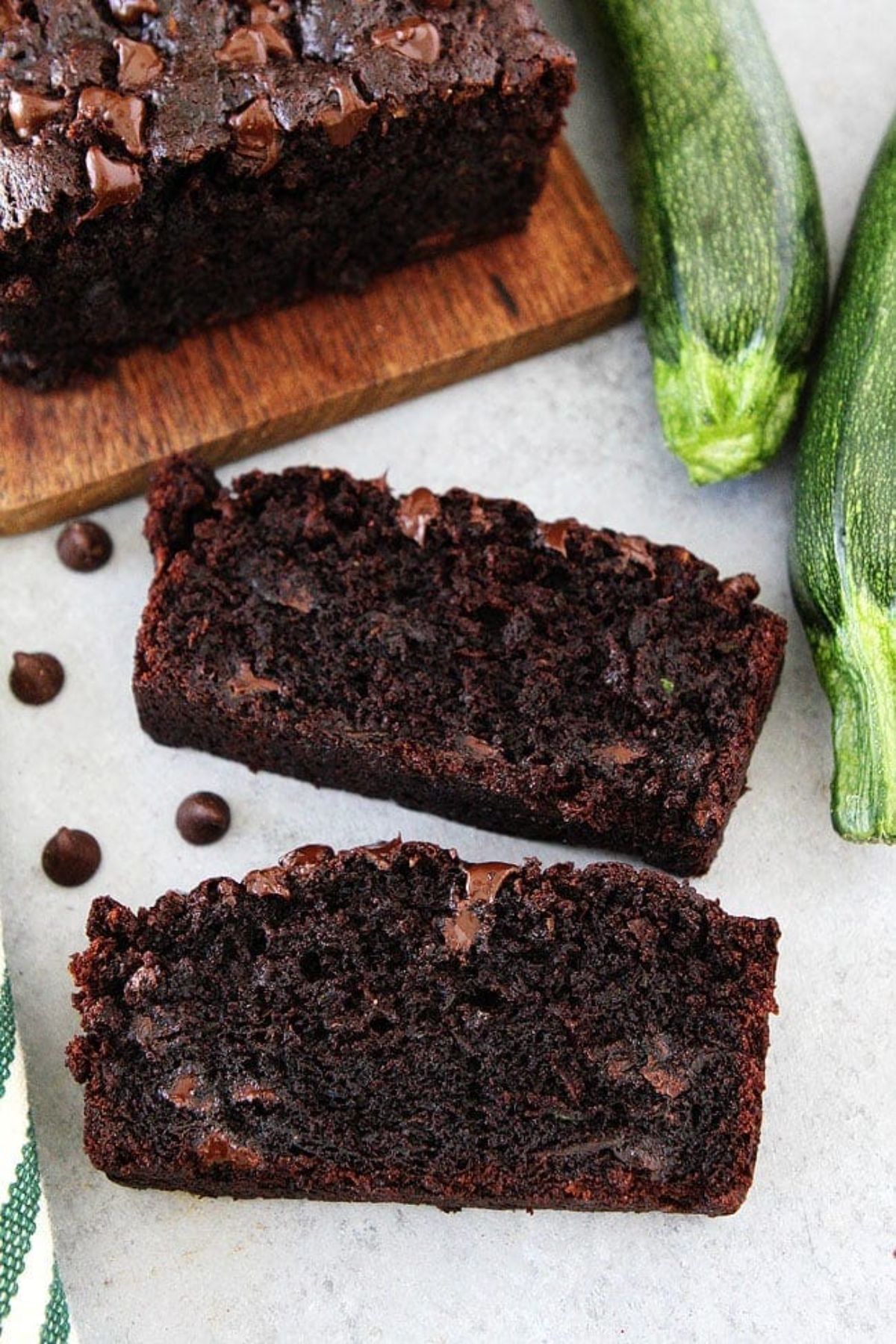 Two slices of Chocolate Zucchini Bread on a table.