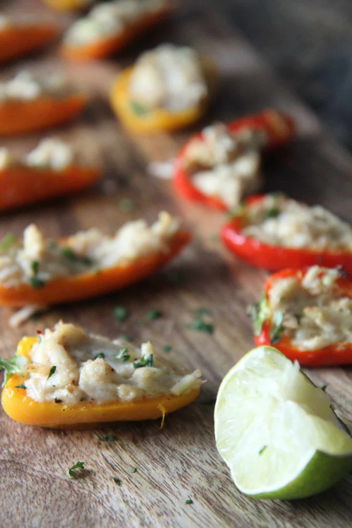 Delicious Crab Stuffed Peppers on a wooden tray.