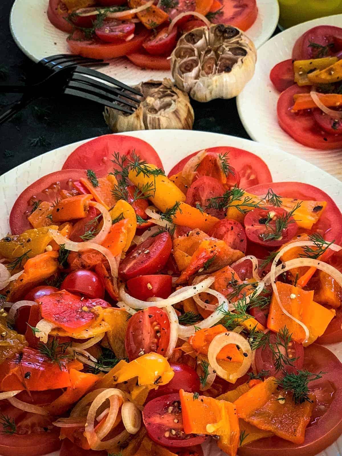 Tasteful Baby Bell Peppers Salad with Roasted Garlic on a white plate.