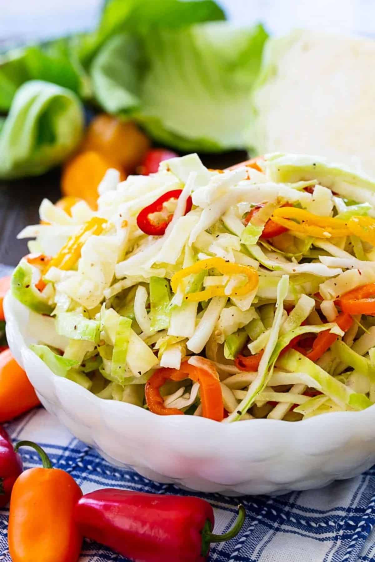 Healthy Marinated Cabbage and Sweet Pepper Slaw in a white bowl.