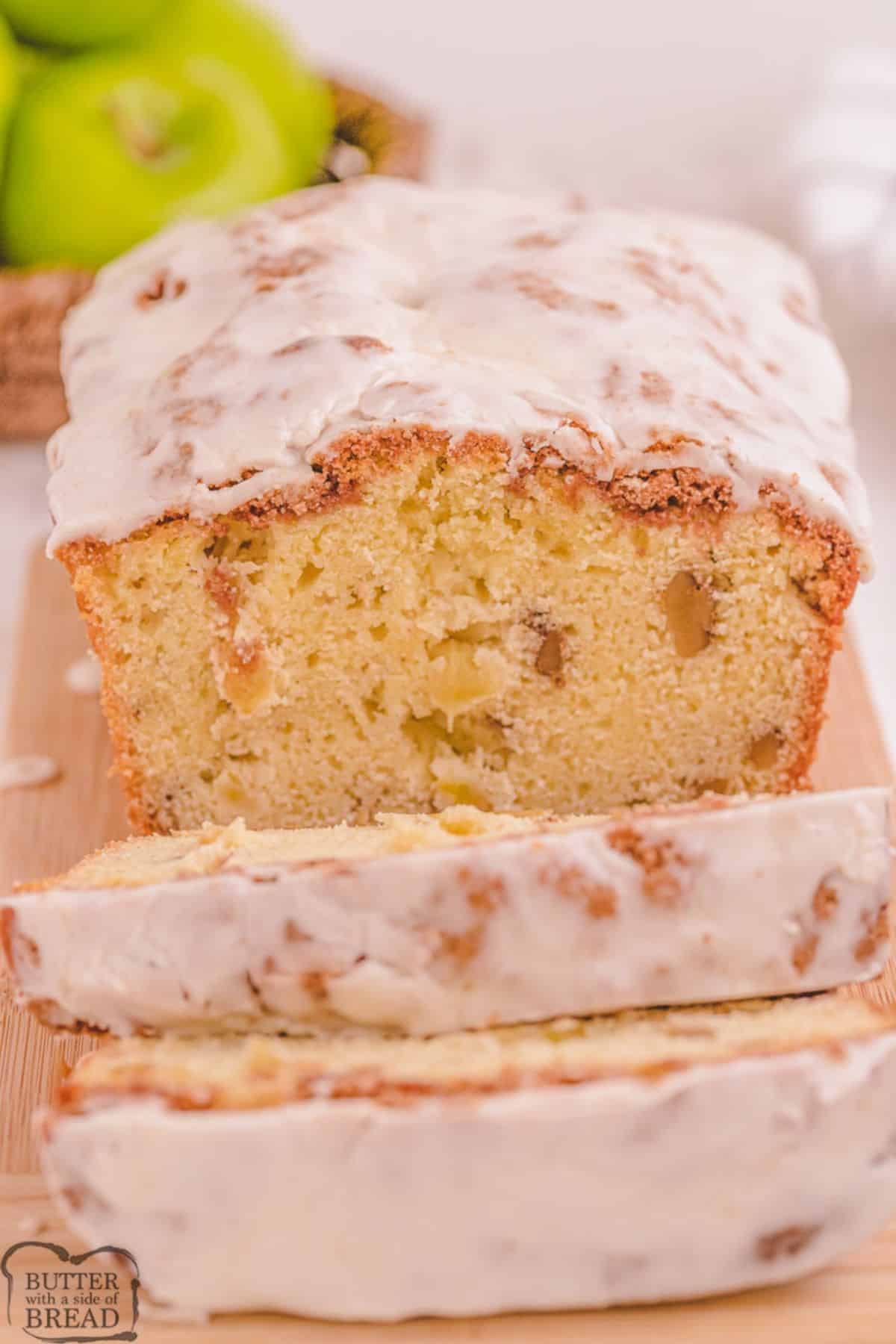 Partially sliced Dutch Apple Bread on a wooden cutting board.