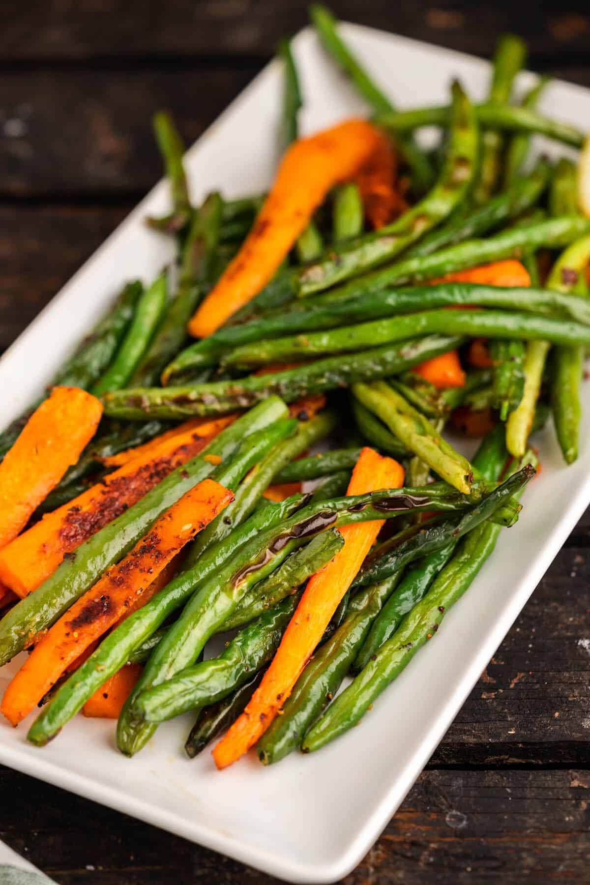Healthy Oven-Baked Green Beans and Carrots on a white tray.