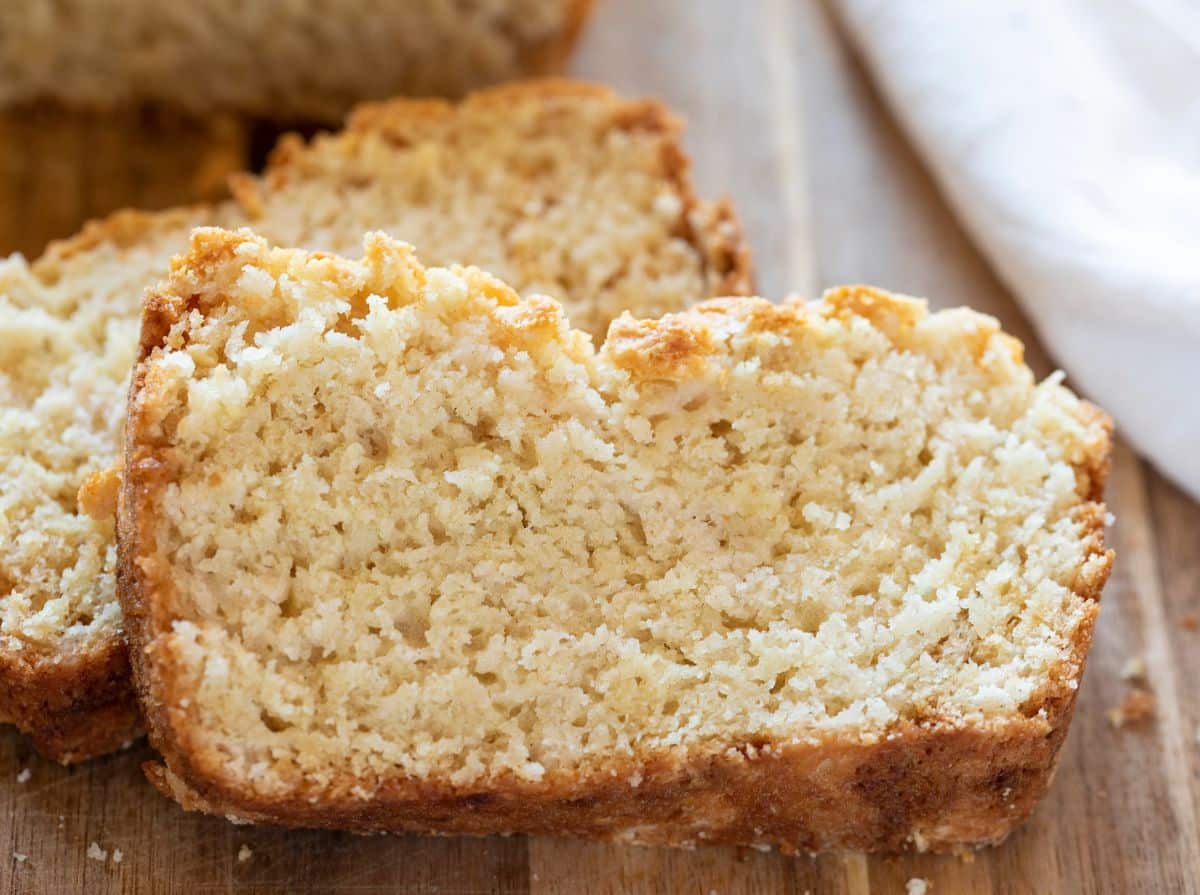 Two slices of Buttermilk Sweet Bread on a wooden tray.