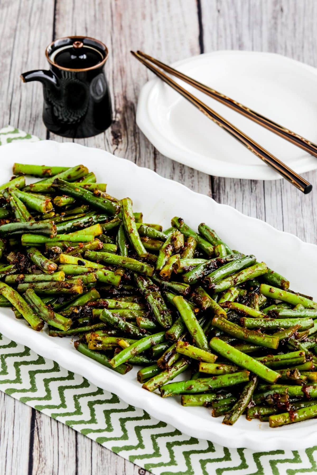 Yummy Low-Carb Spicy Szechuan Style Green Beans on a white tray.