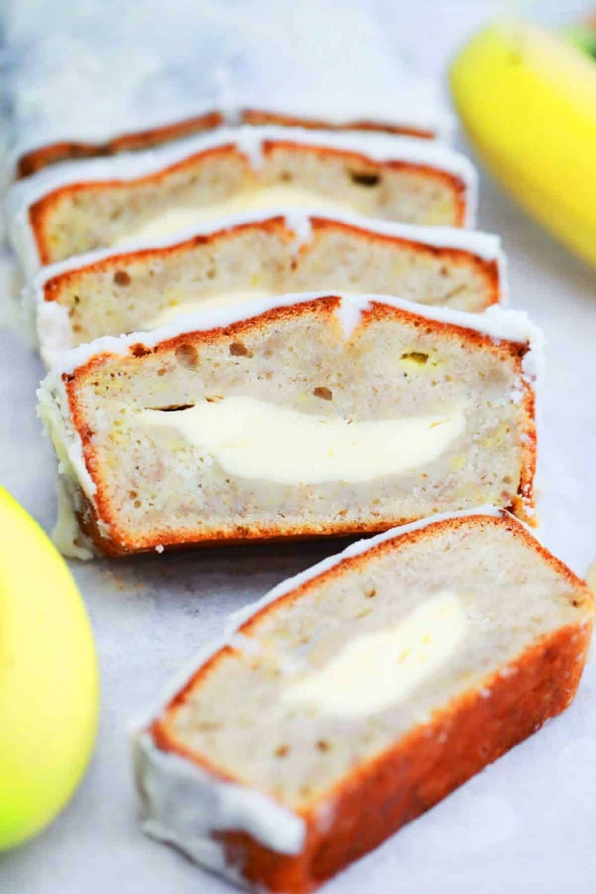 Partially sliced Cheesecake Banana Bread on a tray.