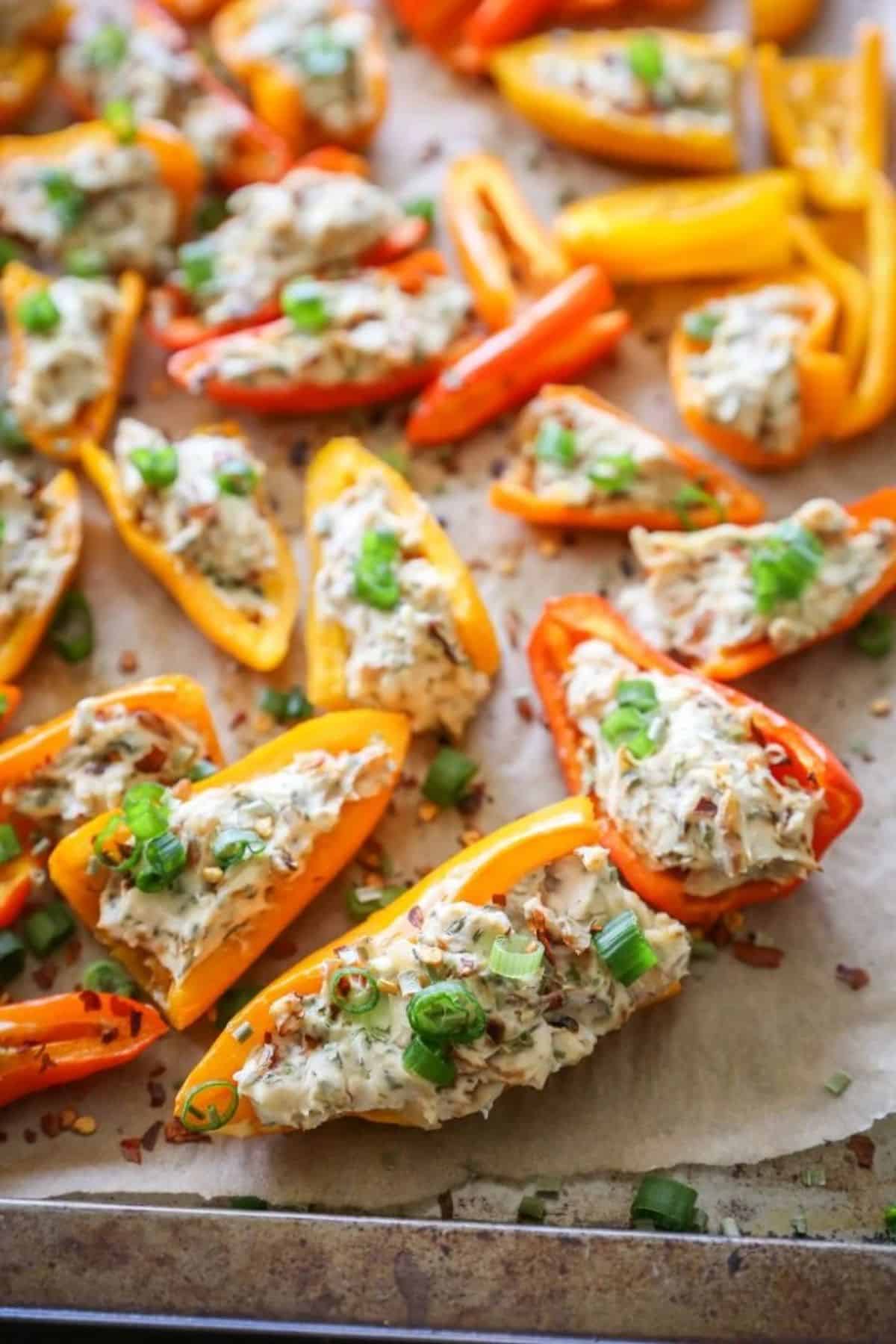 Delicious Cream Cheese Stuffed Baby Bell Peppers on a baking tray.
