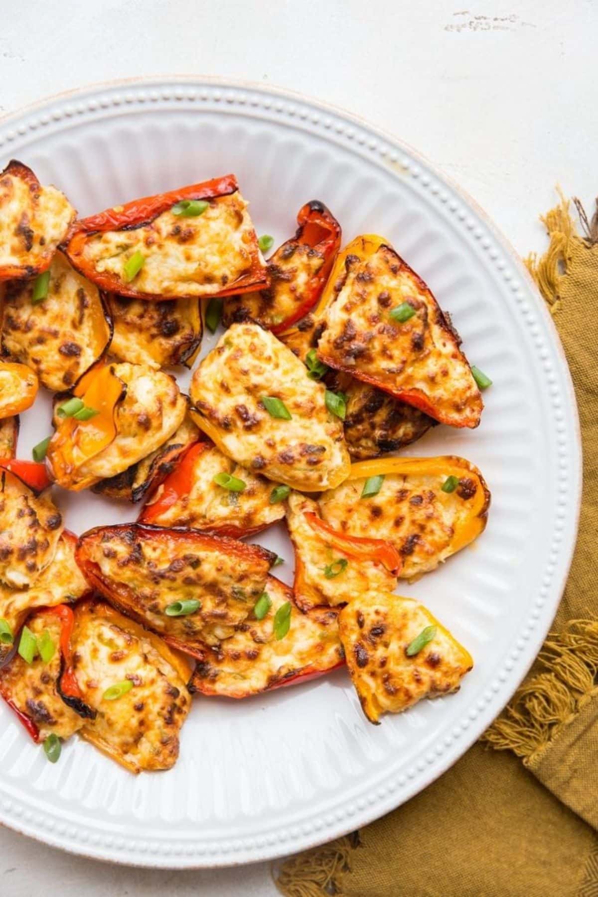 Flavorful Air Fryer Cream Cheese Stuffed Mini Peppers on a white plate.