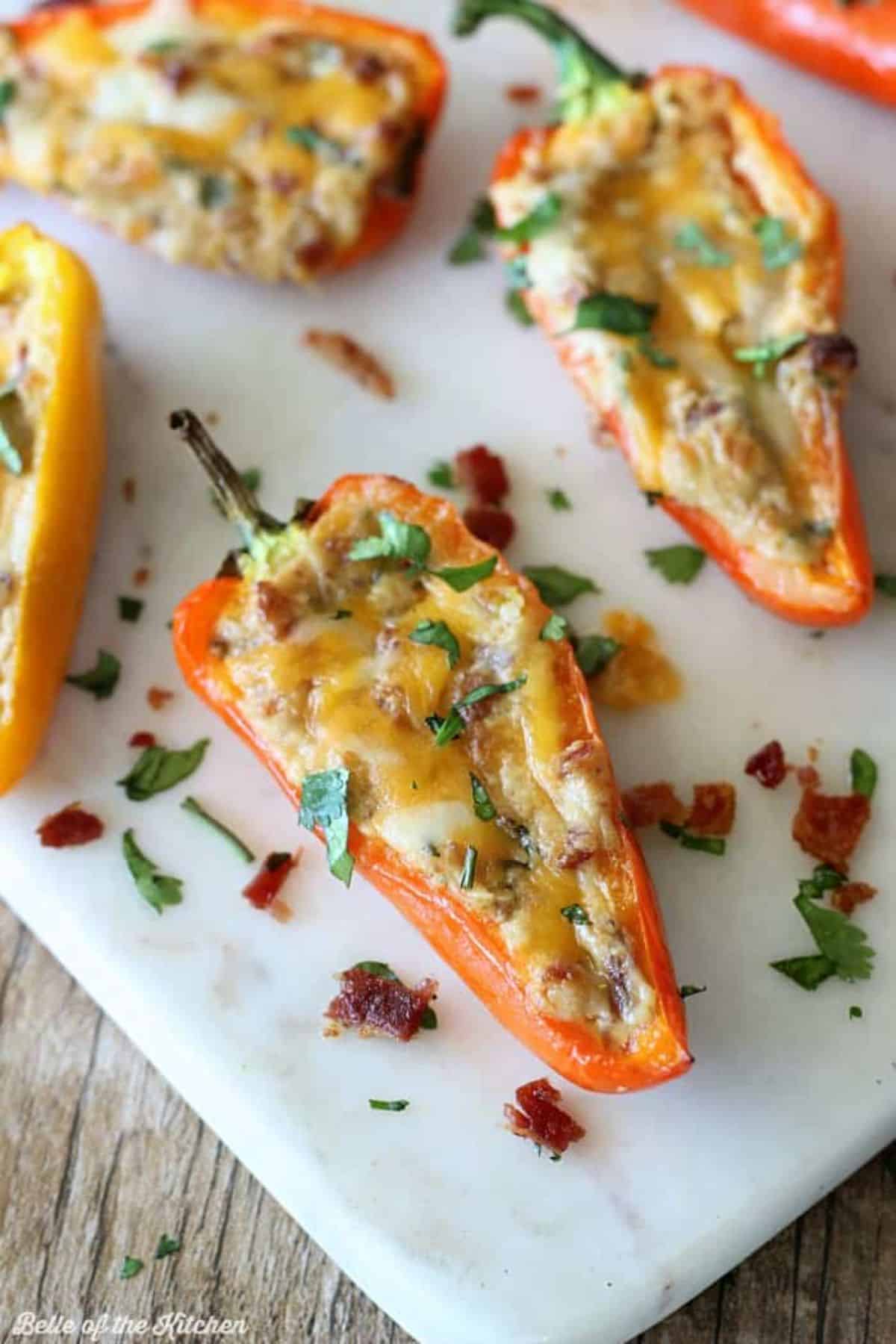 Tasty Cheesy Bacon Stuffed Mini Peppers on a white tray.