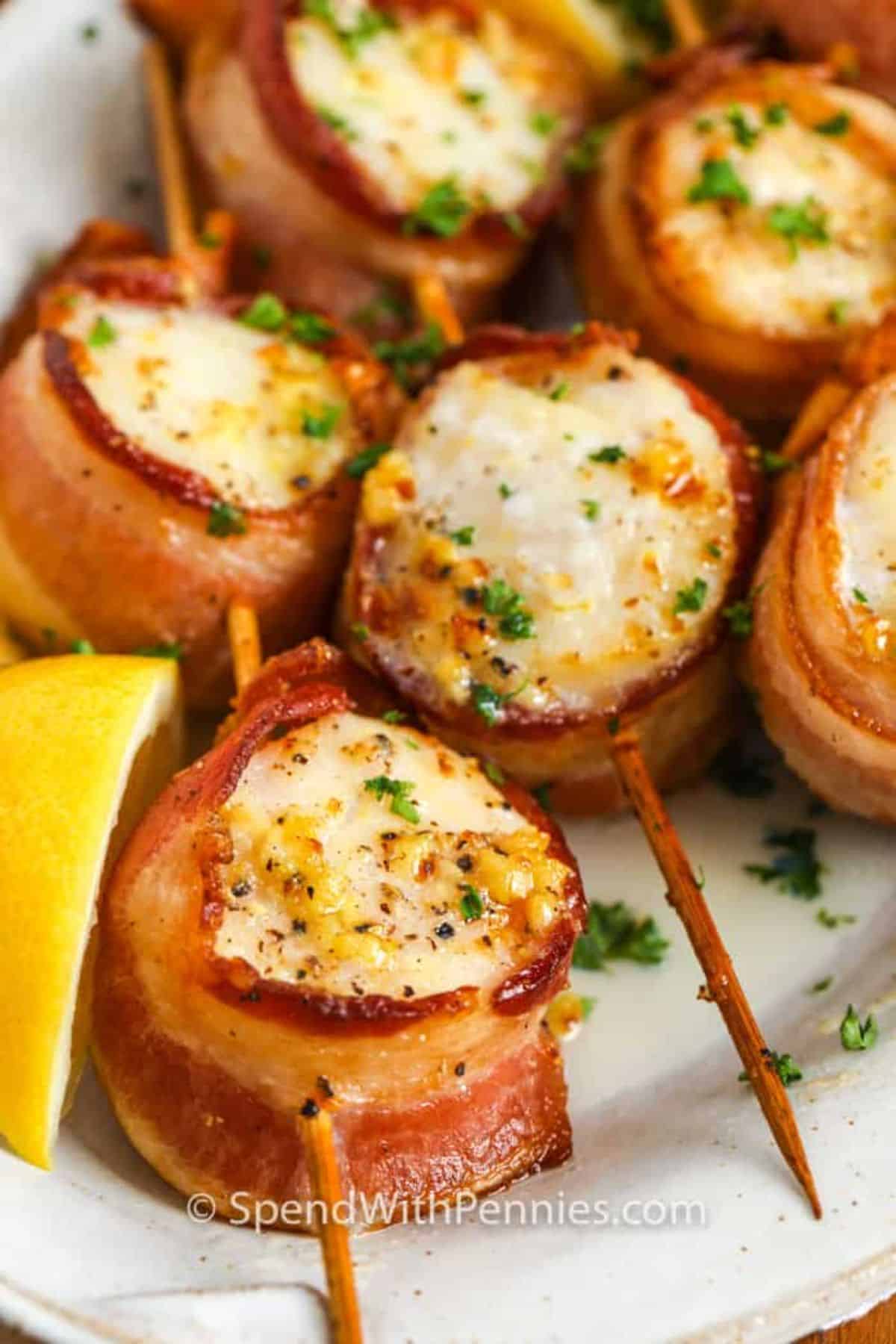 Delicious Bacon Wrapped Scallops on a white tray.