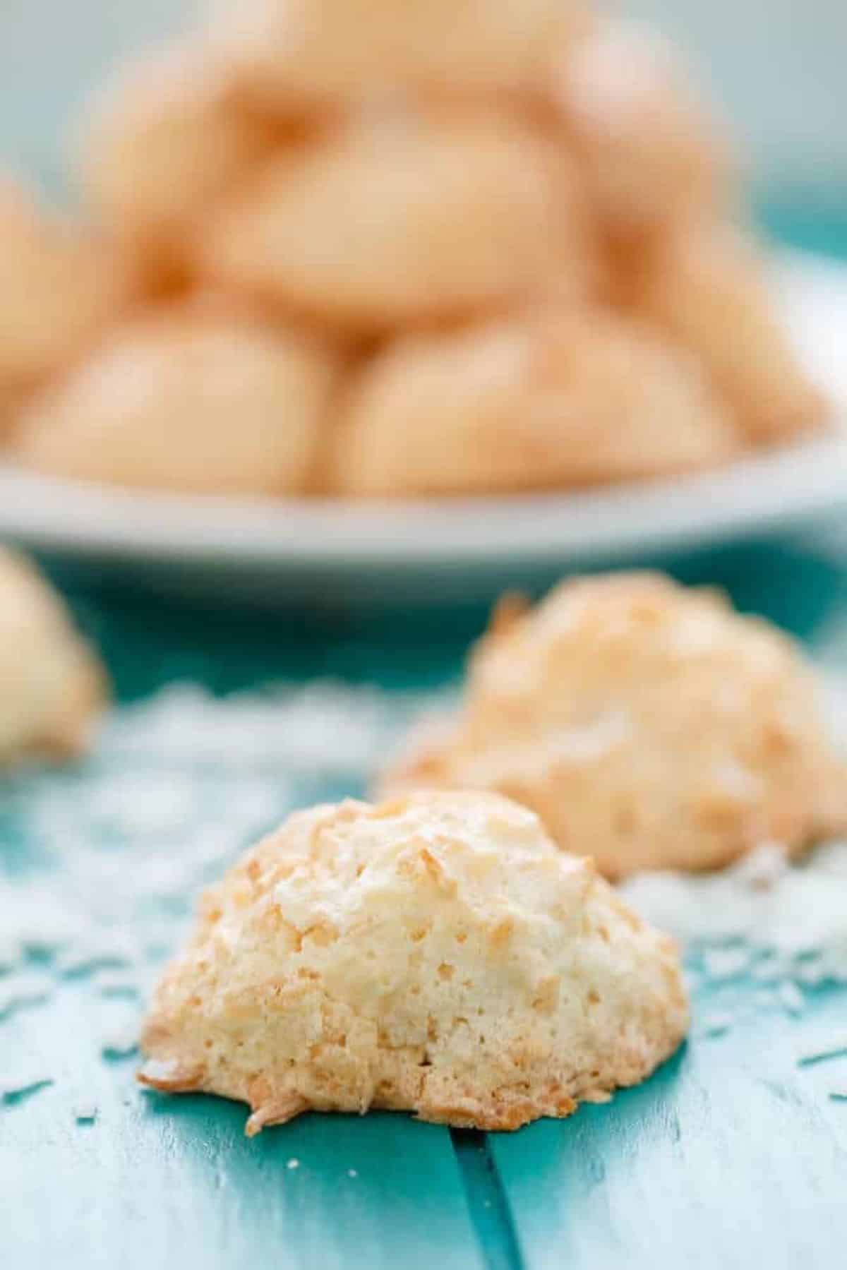 Crunchy Semi Toasted Coconut Macaroons on a blue wooden table.