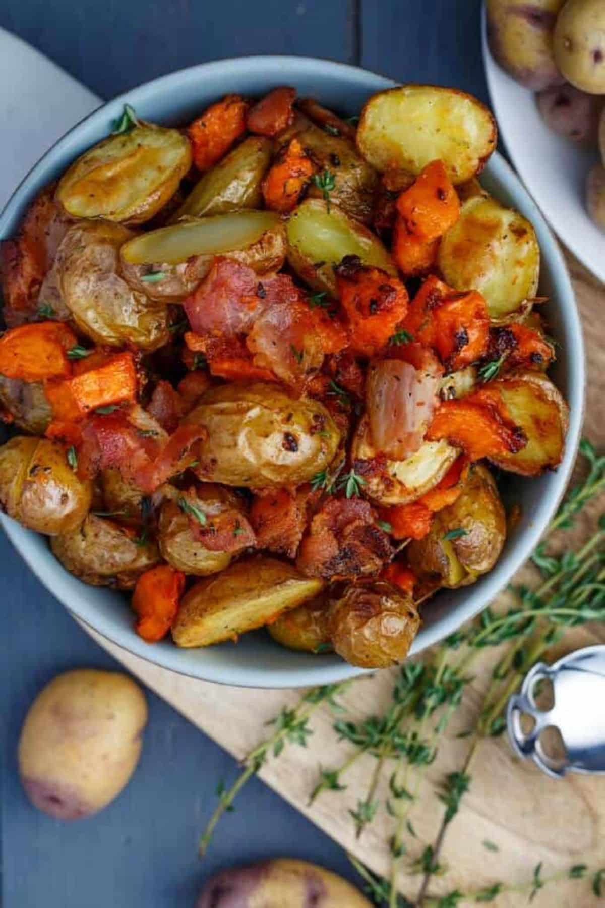 Healthy Roasted Bacon Thyme Potatoes in a blue bowl.