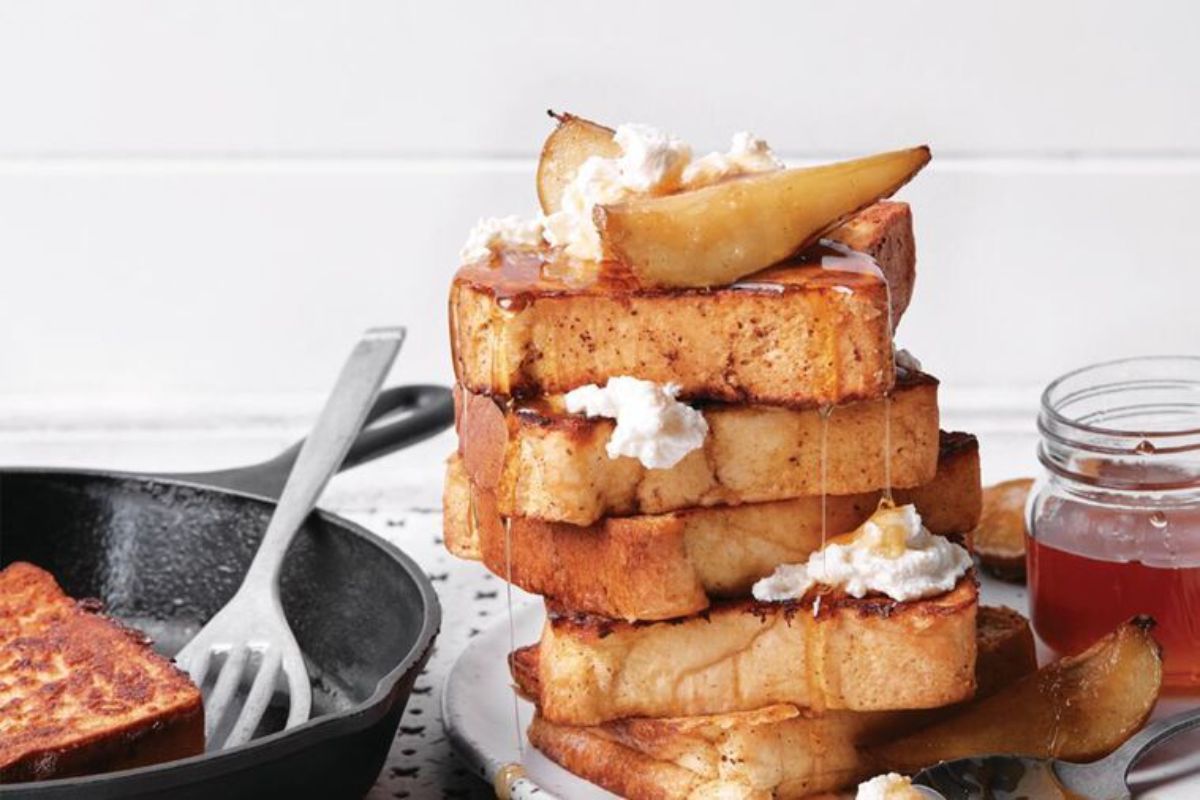 A pile of French Toast with Caramelized Pears and Ricotta on a plate.