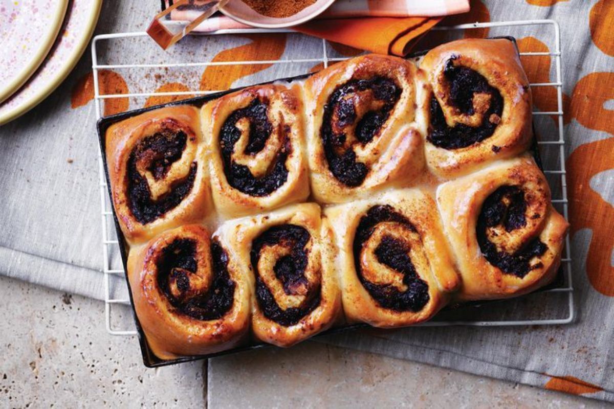 Scrumptious Cinnamon and Date Rolls on a resting grid.