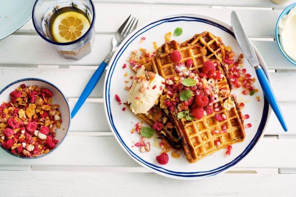 A pile of French Toast Waffles with Berry Brekkie Crunch on a plate.