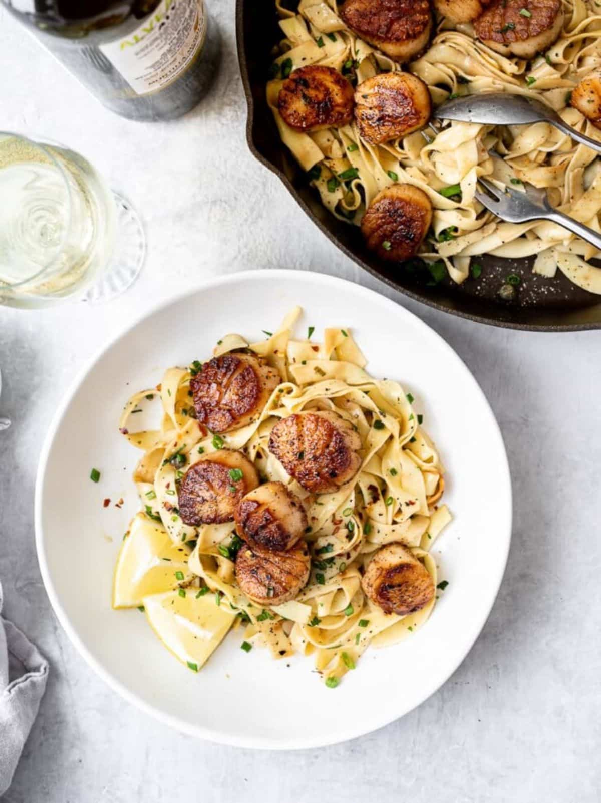 FLavorful Pan Seared Scallops with Lemon Pasta in a white bowl.