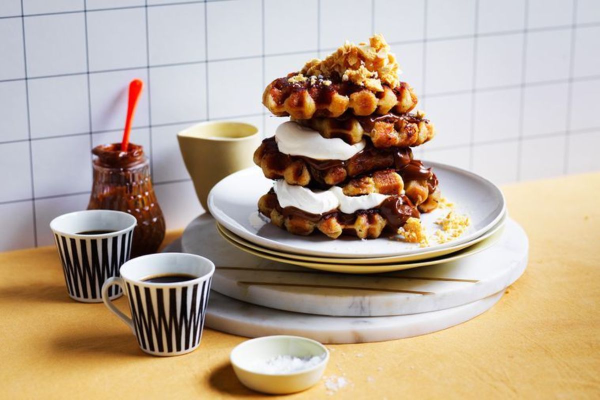 A pile of Salted Caramel, Honeycomb Waffle French Toasts on a plate.