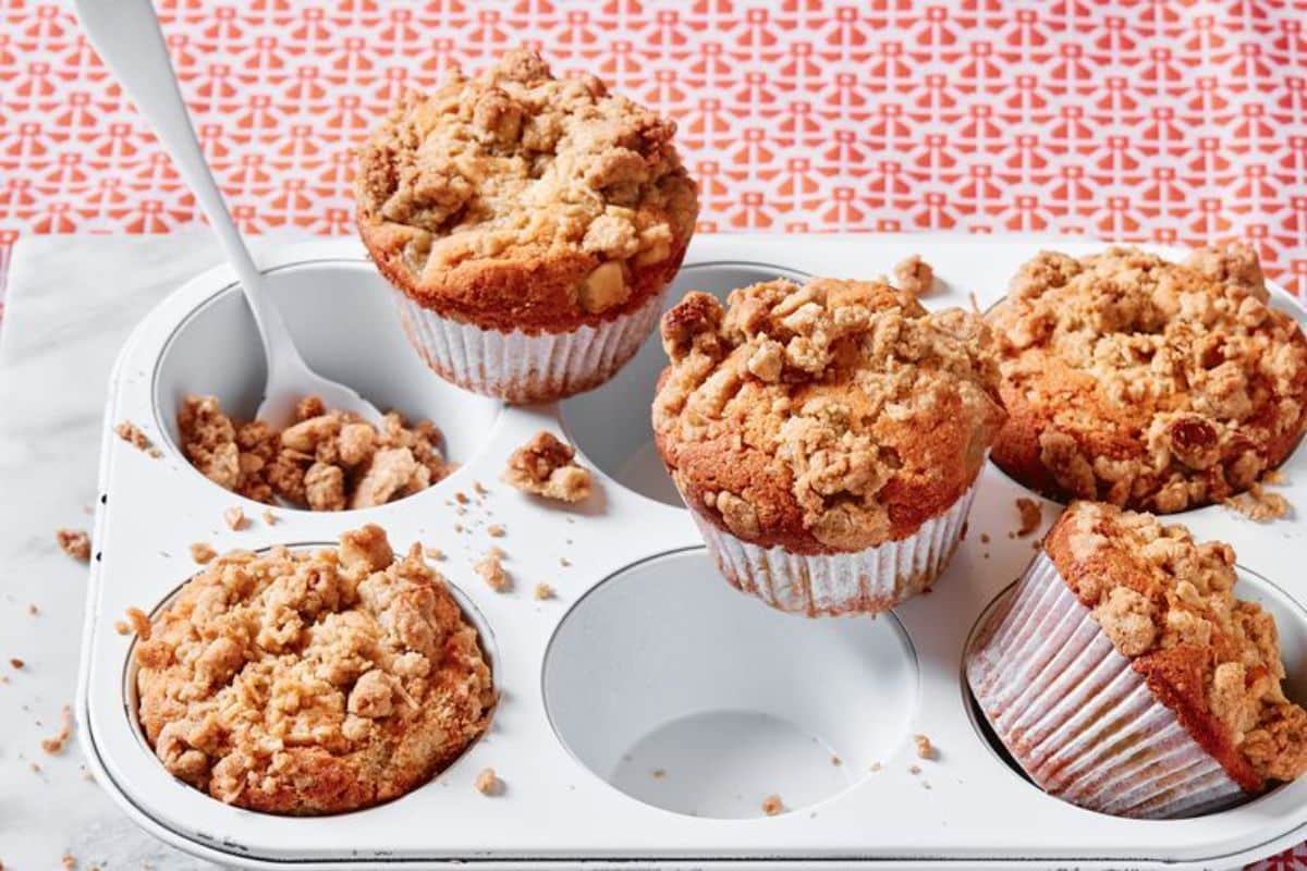 Flavorful Pear and Coconut Crumble Muffins in a muffin tray.