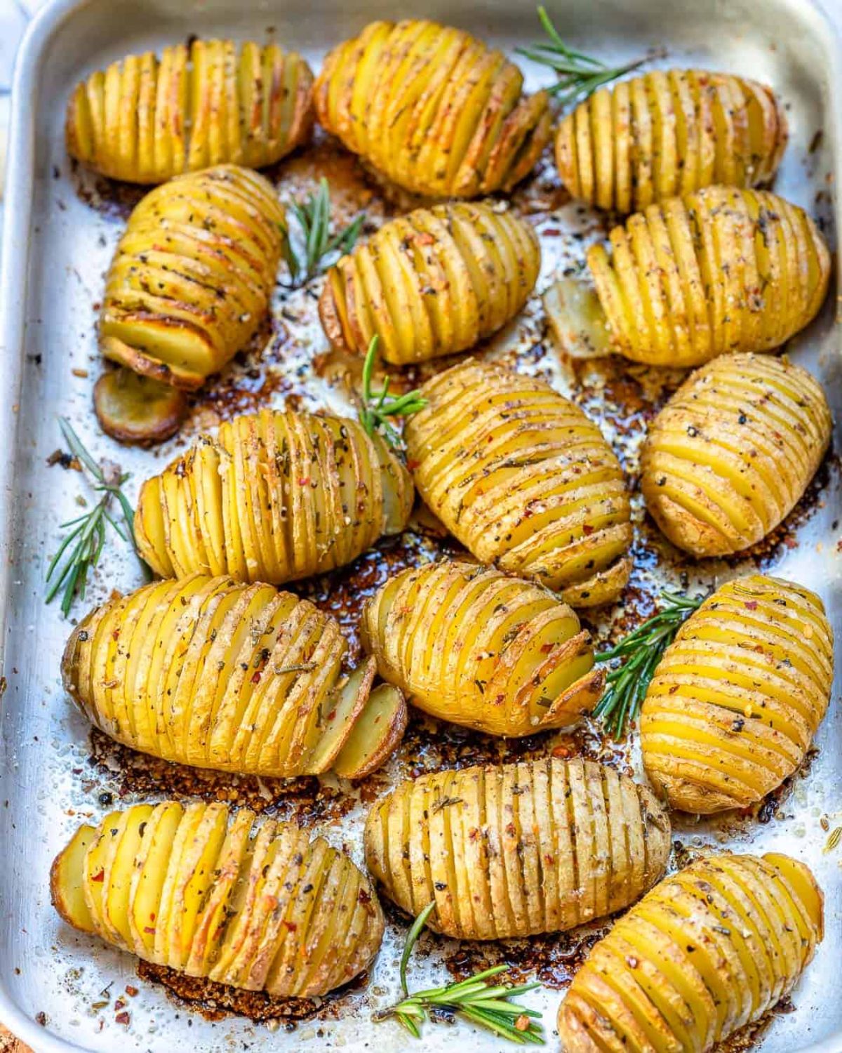 Mouth-watering Garlic Butter Baked Hasselback Potatoes on a baking tray.