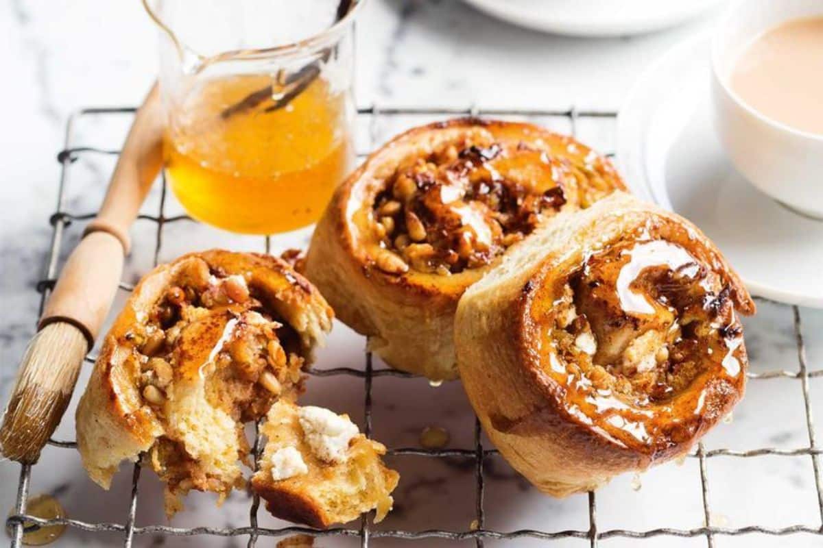 Scrumptious Spiced Apple Chelsea Buns on a resting grid.