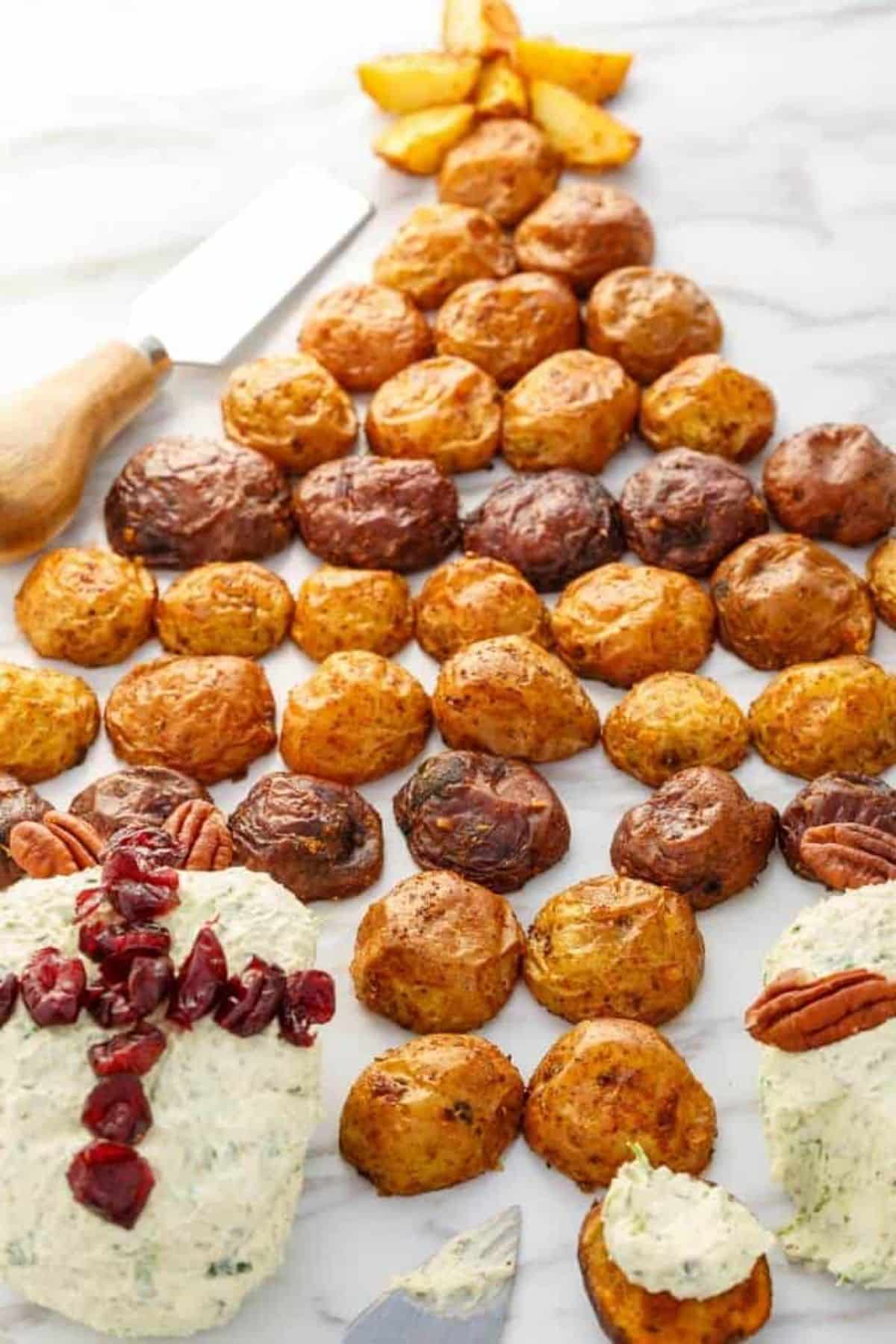 Tasty Holiday Cheese Ball with Roasted Potatoes on a table.