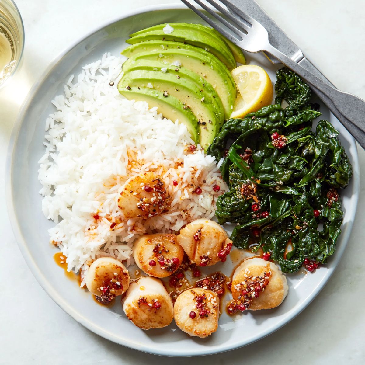 Scrumptious Scallop Rice Bowl with Crunch Spice Oil with cutlery.