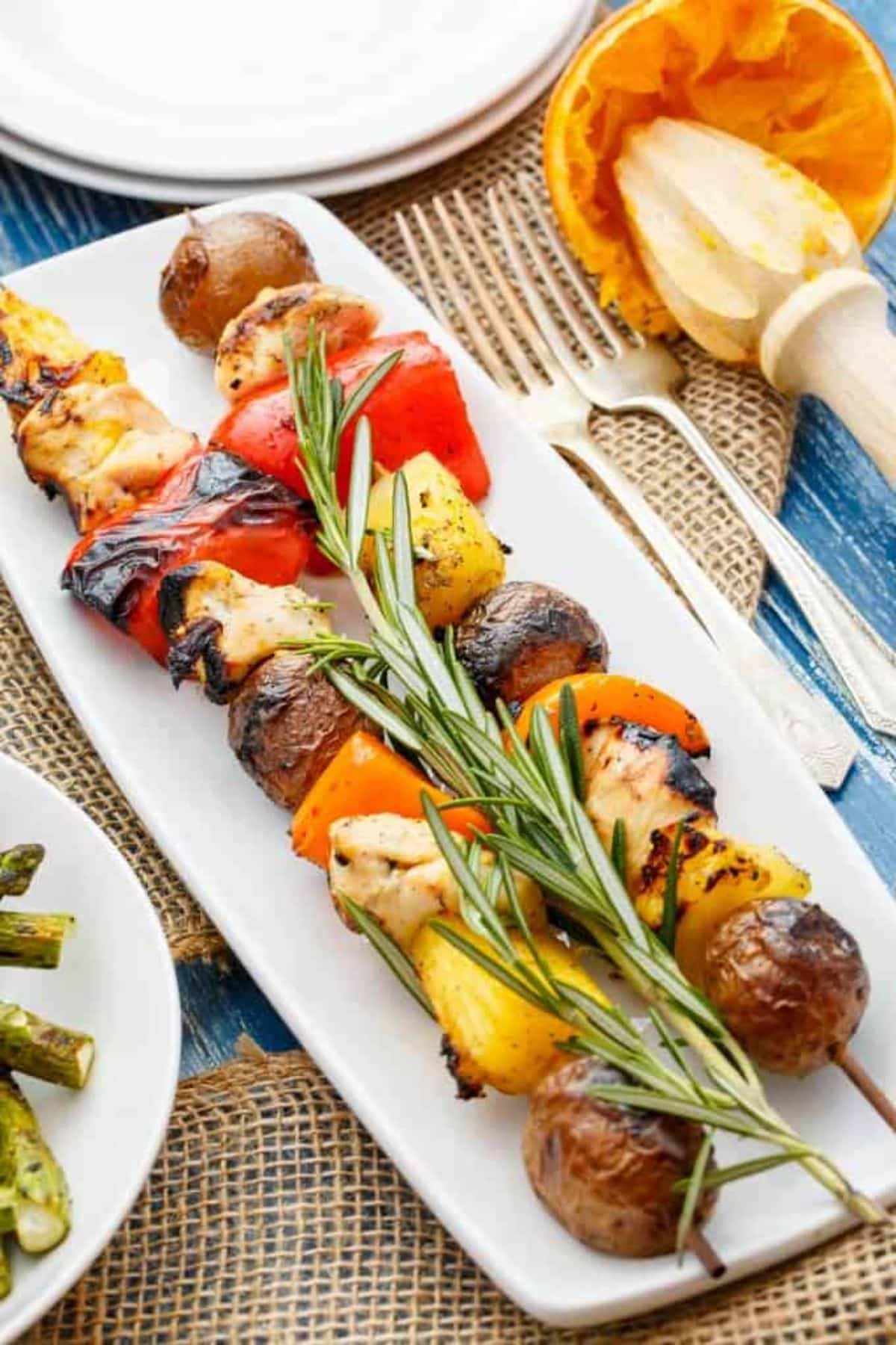 Scrumptious Orange Chicken Pineapple Potato Kabobs on a white tray.