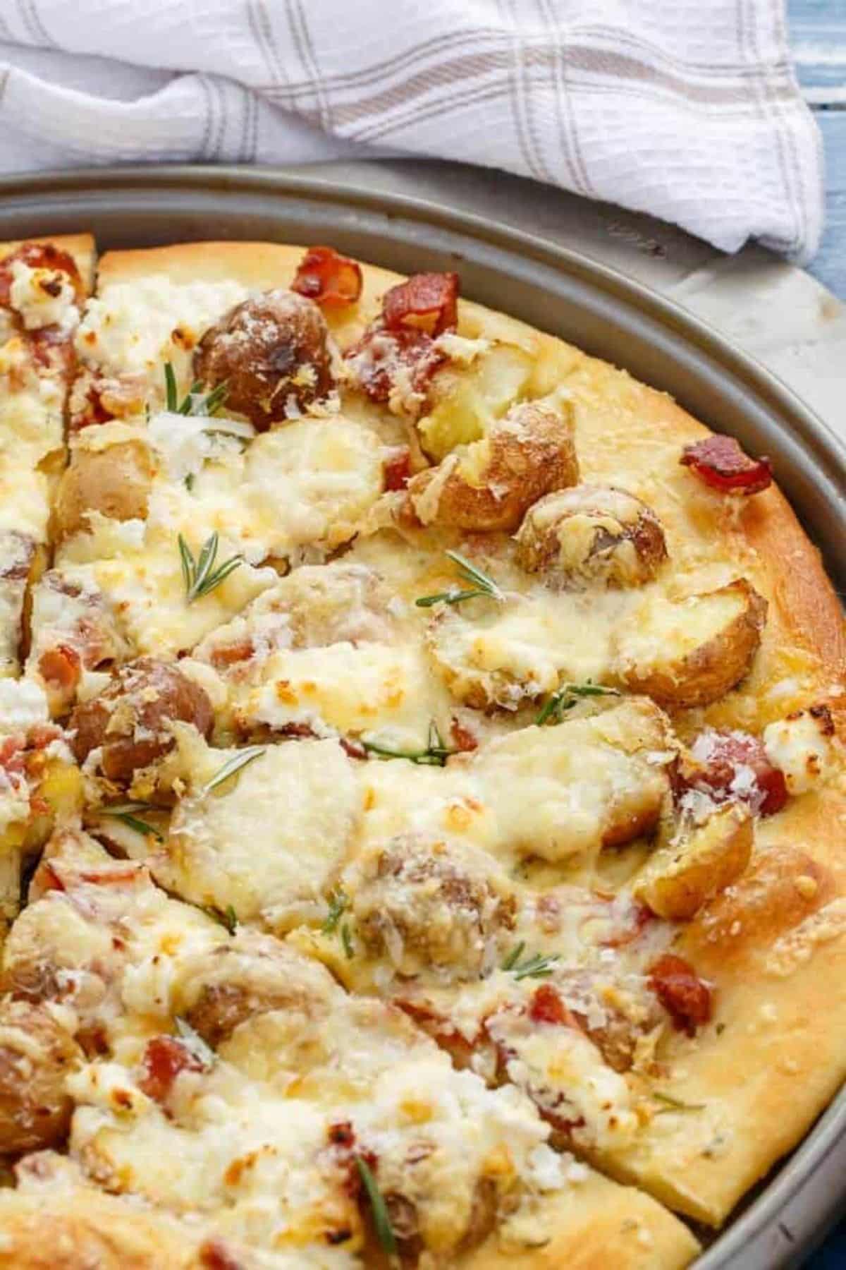 Tasty Thin Crust Bacon Potato Pizza in a gray tray.